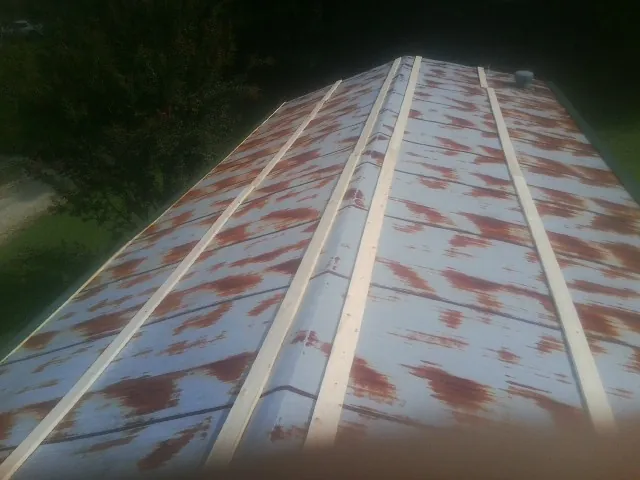 Rusted metal roof panels with new wood purlins before replacement — Storm Damage Roof Repair in San Marino by Roofing Brothers